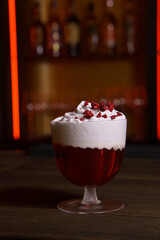 Cocktail in a tall glass against the background of a dark bar