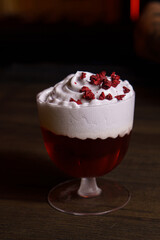 Cocktail in a tall glass against the background of a dark bar