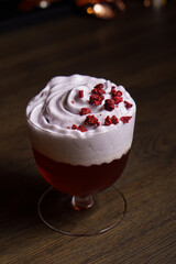 Cocktail in a tall glass against the background of a dark bar