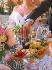 A festive table on a sunny day with lots of snacks