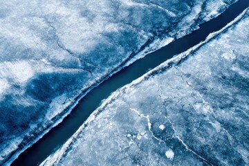 Frozen river flowing through winter landscape