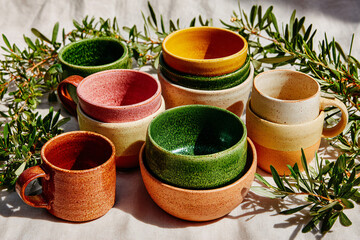 Friendsgiving Potluck Overhead with Mismatched Ceramics, Sharing Bowls and Olive Branches