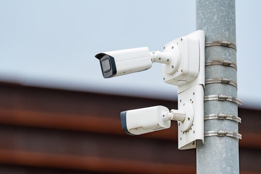 2 security cameras mounted on the pole