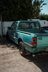 Old turquoise pickup truck parked on a sunny street in Algarve, Portugal © Sandor Szmutko