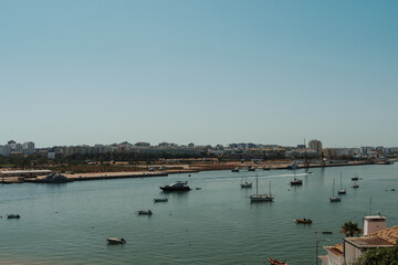 Fototapeta premium Scenic view of Portimão waterfront with boats on the Arade River, Algarve, Portugal
