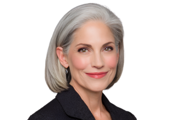 Photo of the TV host with gray hair, wearing a navy suit and white shirt. He is smiling slightly at the camera and standing on a transparent background. 