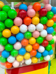 Colorful gumballs in a vending machine delight young and old alike