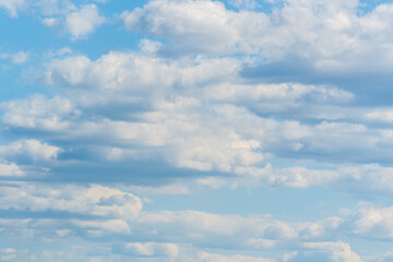Blue sky background with white clouds.