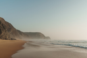 Golden hour waves and mist along Praia da Cordoama, Algarve, Portugal