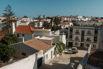 Obraz premium View of Faro old town with tiled roofs and dome of Igreja do Carmo, Algarve, Portugal