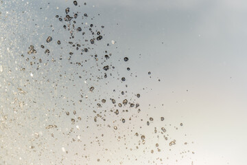 Splashes and jets of water against light background.