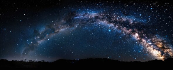 Fototapeta premium Night sky panorama with Milky Way arching over dark landscape
