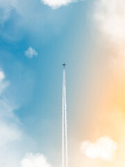 Airplane flying high with contrails against a blue sky.