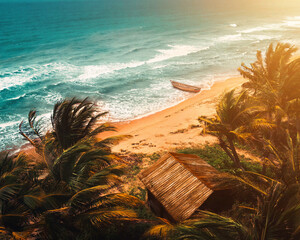 Tropical beach with palm trees, a wooden hut, and a boat on the shore at sunset.