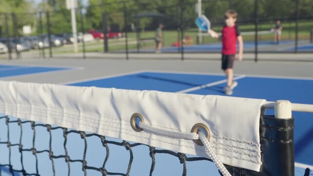Happy Children Playing Pickleball Game Hitting, Pickleball Yellow Ball With Paddle, Outdoor Sport Leisure Kids Activity. Athletic Child Hits Ball With Pickleball Racket. Outdoor Sport Leisure Activity