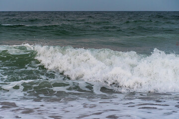 Powerful ocean wave crashing with foamy splash close up view