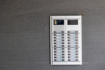 Intercom system showing multiple apartments on building exterior wall