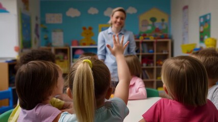 Group of diverse children sitting at table in preschool classroom raising hands to answer teacher's question, learning and education concept - Powered by Adobe