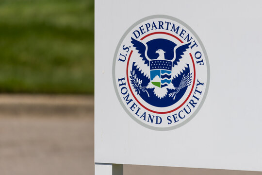 Border Protection and badge for US. Department of Homeland Security on white board.