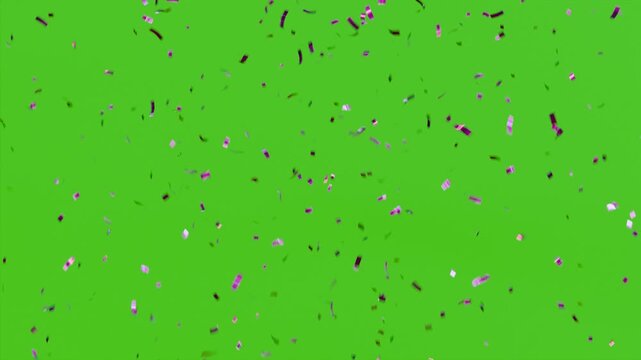 Bright colourful confetti falling in motion on green screen background. Festive decoration element for party invitations, New Year’s events, birthdays, and digital design