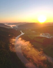 Sunrise over winding river valley