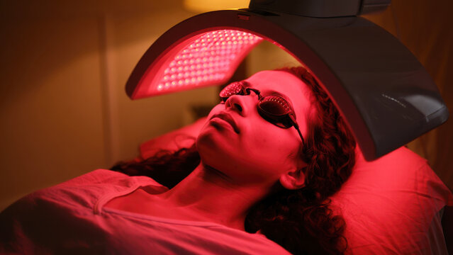 LED red light therapy dome, infrared facial rejuvenation session, wellness treatment for skin, anti-aging light care, professional beauty procedure, clinical glow therapy