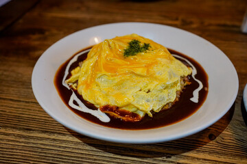Japanese omurice omelette with rice and kurobuta (black pig) sausage. 