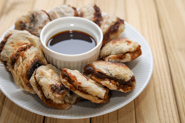 Pempek tunu. indonesian grilled fish cake served with cuko or sour and spicy dip sauce.
