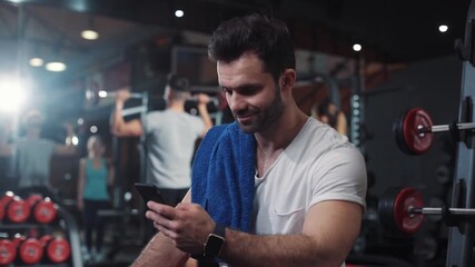 Portrait guy in gym while resting between a workout uses phone body strength fit health male strong healthy muscular athlete guy physical young arm model mobile caucasian endurance close up - Powered by Adobe