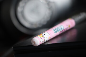 Writing Pen on Traditional Craft Surface with Dim Lighting  Polpen Close-Up on Rustic Cultural Background in Dark Tone © Nawassyarif .