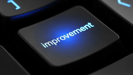 Fototapeta premium Close-up of Illuminated Keyboard Key with Improvement Word in Focus