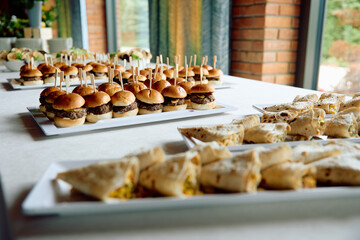 Mini burgers and wraps arranged for event catering