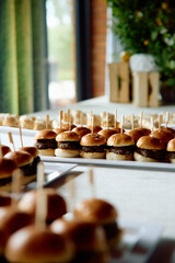 Mini beef sliders arranged on trays for serving