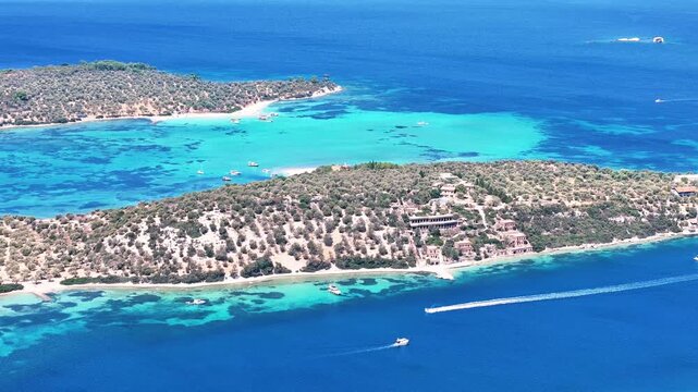 4k drone video of Garip and Kalem islands with turquoise sea and coral reefs in Bademli. Dikili, a district of Izmir famous for its turquoise sea in Turkiye.