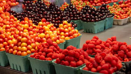 Prosciuttos, sausage and fruits in public market of Granville Island, Vancouver, BC, Canada