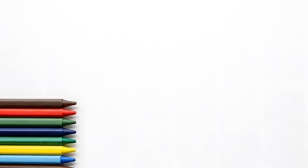 Fototapeta premium A Colorful Array of Crayons Lined Up Against a Blank Canvas, Perfect for Artistic Expression and Creativity