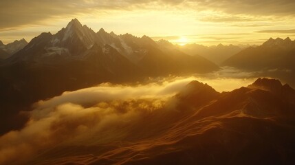 Golden sunrise over alpine peaks, shrouded in mist
