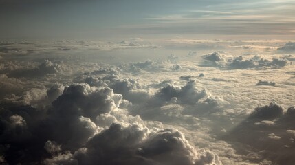 Aerial view of a dense cloud layer with light breaking through, creating a dramatic scene