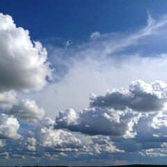 Obraz premium Cumulus clouds against a blue sky