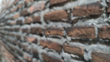 Blurred photo Detailed texture of handmade terracotta bricks with natural color variations. Earthy tones and traditional craftsmanship bring warmth to any high-quality project.