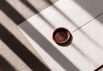 Minimalist Wedding invitation announcement. Minimalist envelope with wax seal in sunlight and striped shadow