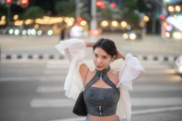 Fototapeta premium Sexy fashion woman posing in the night city with bokeh lights.