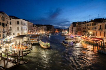 Blur Night view of grand canal with boats, gondolas, mansions along. Venice, Italy.
