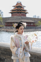Woman wearing traditional Chinese dress in forbidden city, Beijing, China.
