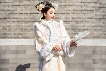 Woman wearing traditional Chinese dress in the ancient City, Beijing, China.