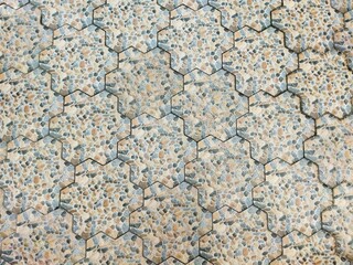 Seamless hexagonal stone tile pattern with natural pebble texture in earthy tones. Ideal for flooring, walls, outdoor surfaces, and background design in modern architectural projects
