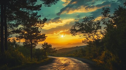 Scenic mountain road at sunset, trees and clouds