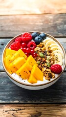 Vibrant fruit and granola bowl on rustic wood