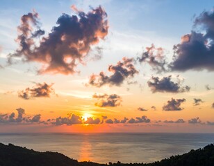 Vibrant sunset over a calm ocean, clouds painted in hues of orange, pink, and purple