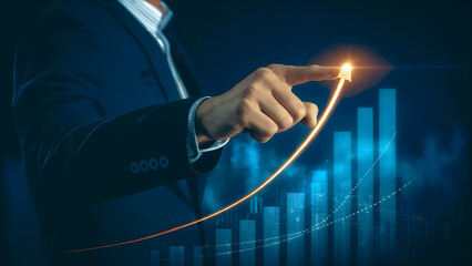 Businessman hand pointing at rising digital financial graph with glowing arrow, representing business growth, investment success, corporate profit, financial progress and upward economic trend